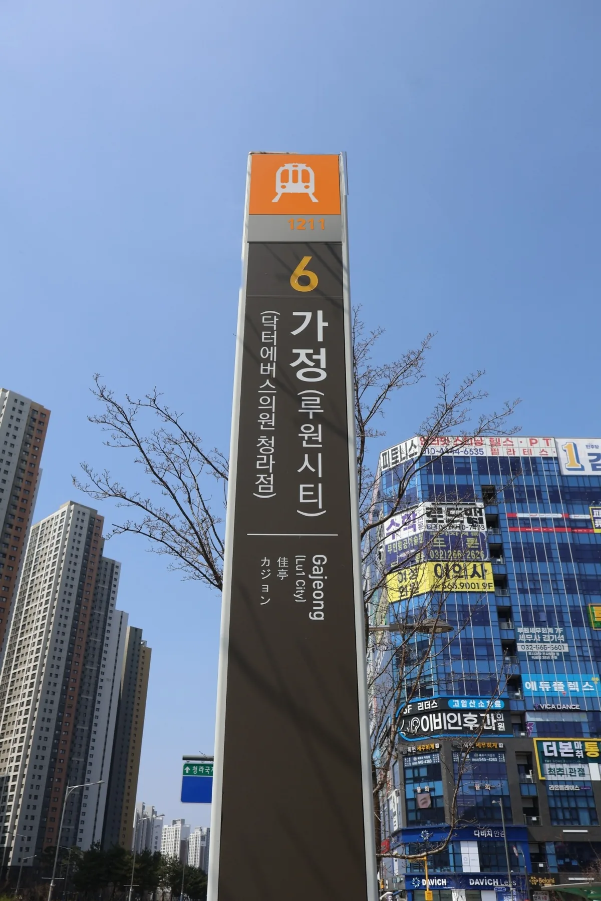 가정역 6번 출구(구 4번) 표지판과 인근 건물